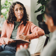 when is women’s mental health month Woman talking to her therapist about when is women's mental health month.