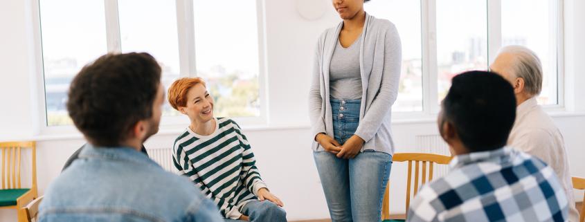 Group therapy session in bright room after asking how long is an inpatient mental health stay​.